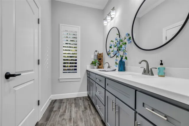 a bathroom with a double vanity sink and a mirror