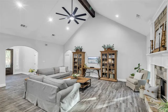 a living room with furniture and a wooden floor