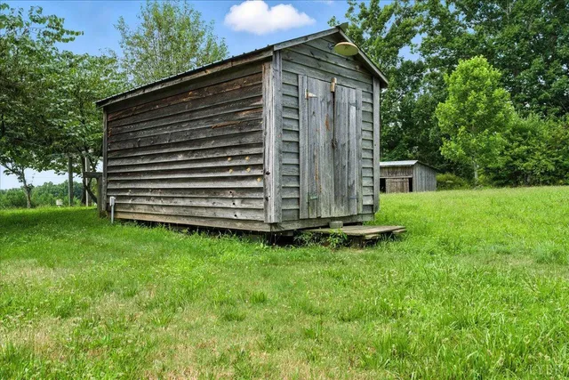 a view of a backyard with a small cabin