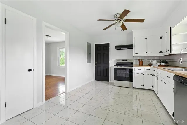 a kitchen with white cabinets and white appliances