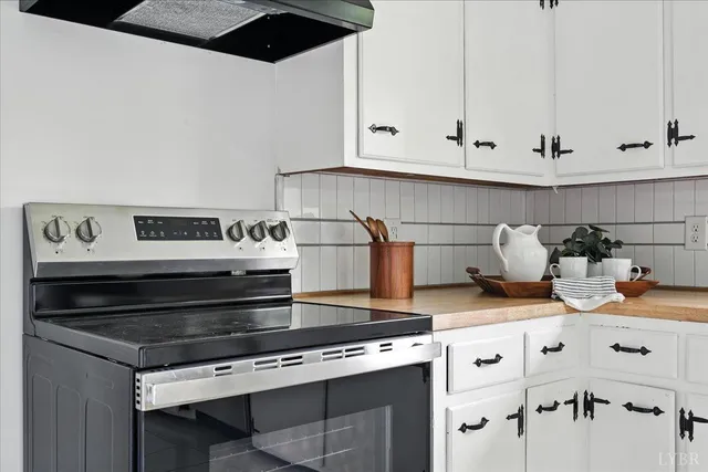 a stove top oven sitting inside of a kitchen