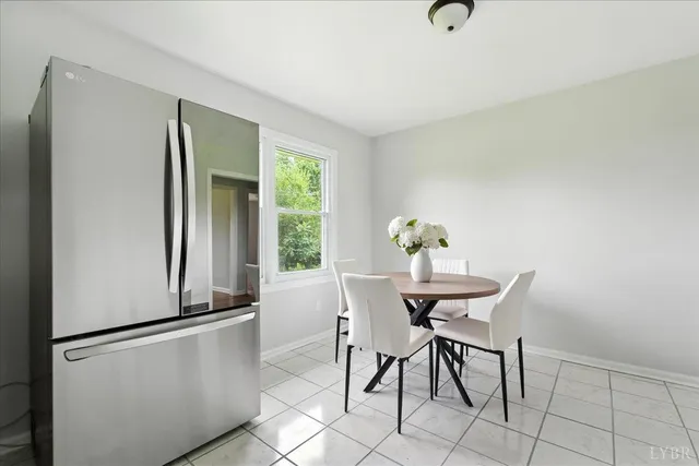 a view of a dining room with furniture and a window