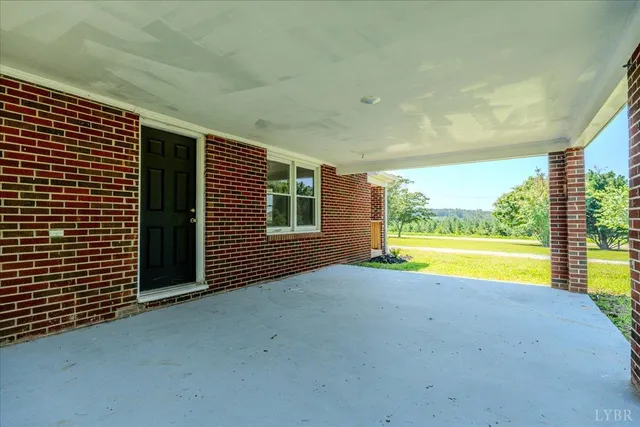 a view of an empty room with a floor to ceiling window and pool table