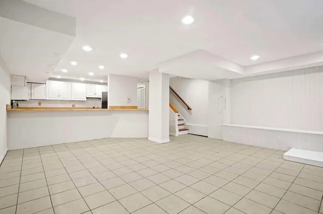 a view of a kitchen with white cabinets