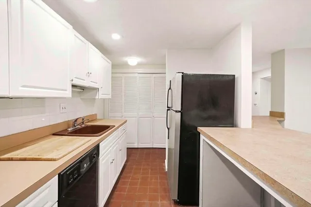 a kitchen with a refrigerator and a sink
