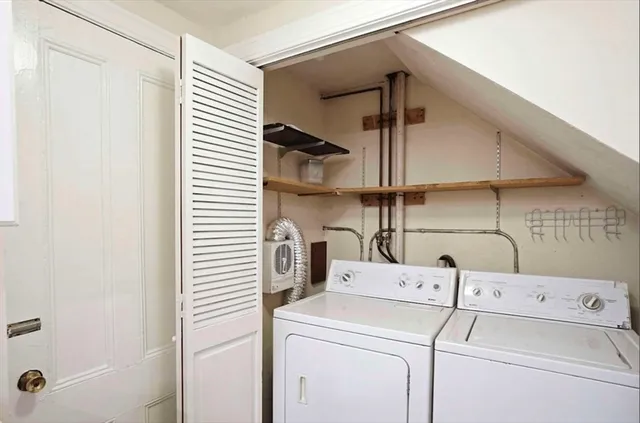a view of storage and utility room with washer and dryer