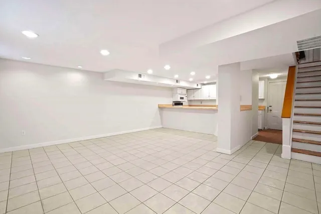 a view of a kitchen with a sink and dishwasher a refrigerator with wooden floor