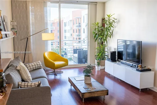 a living room with furniture and a flat screen tv