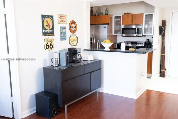 a kitchen with stainless steel appliances a refrigerator and a stove top oven