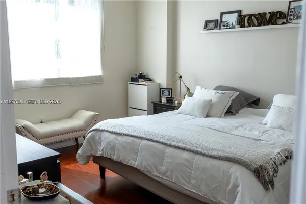 a bedroom with a bed and a couch