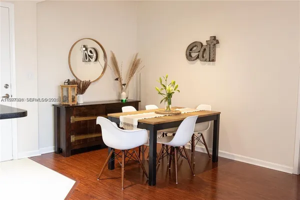 a view of a dining room with furniture and wooden floor