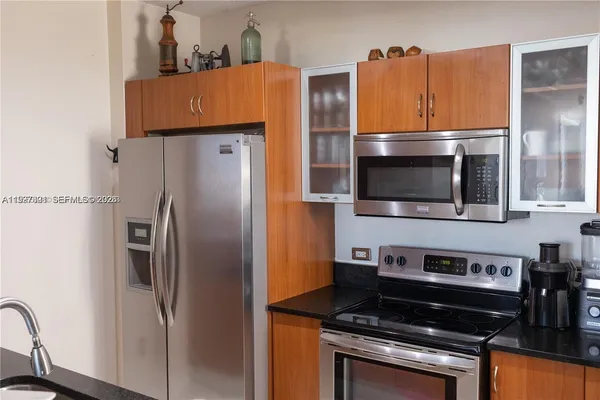 a kitchen with a refrigerator and a sink