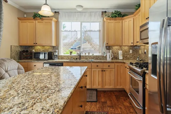 a kitchen with sink refrigerator and window