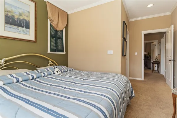 a bedroom with a bed and a painting on the wall