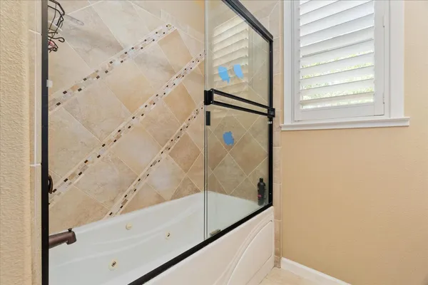 a bathroom with a bathtub and a shower