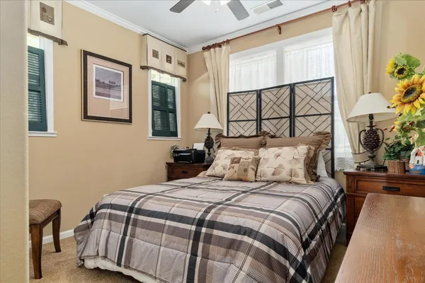 a bedroom with a bed and a painting on the wall