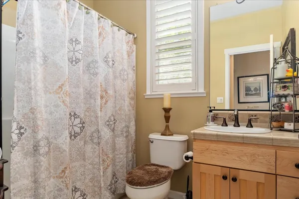 a bathroom with a sink toilet and mirror