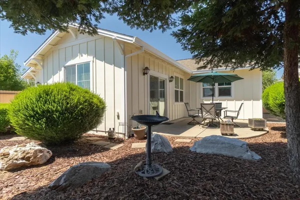 a view of a house with backyard porch and sitting area