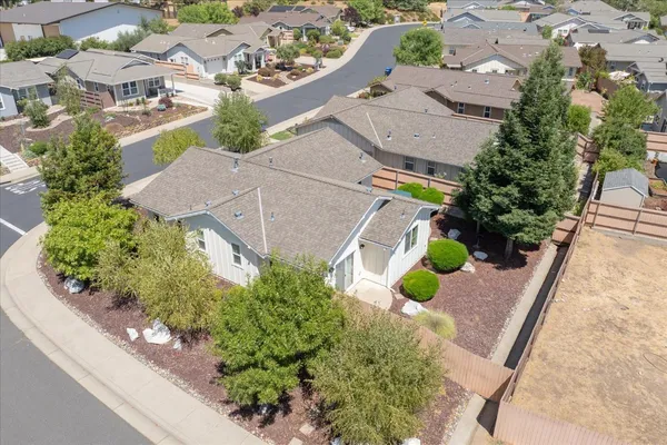 an aerial view of a house with yard and outdoor seating