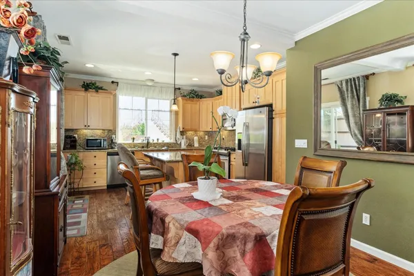 a dining room with furniture and a chandelier