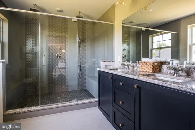 a bathroom with a shower sink and mirror