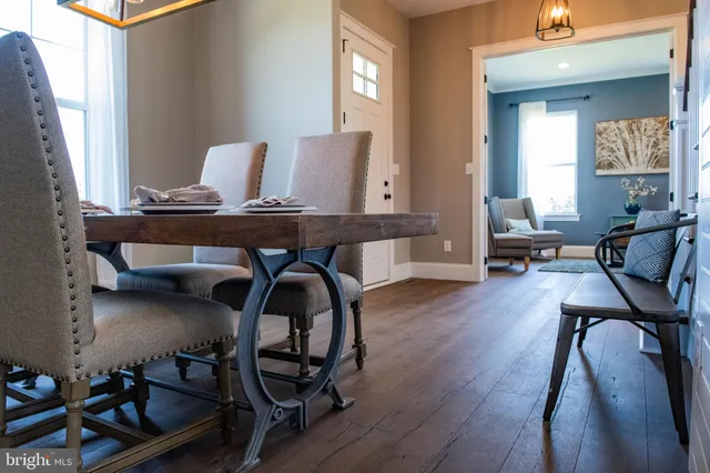 a view of a livingroom with wooden floor and furniture