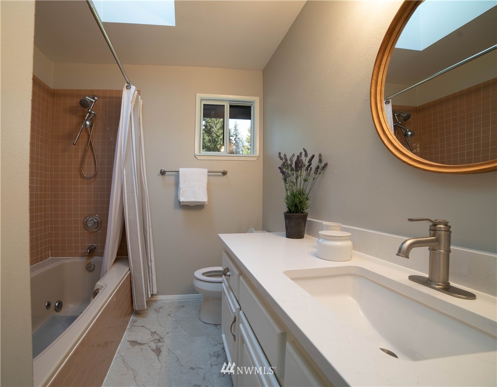 16714 3rd Avenue Southeast Bothell, WA 98012 - Photo 24 of 40 a bathroom with a sink a toilet and a mirror