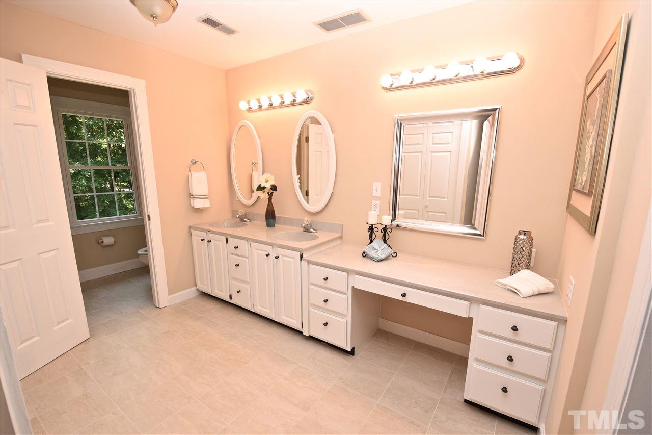 9213 Litchford Road Raleigh, NC 27615 - Photo 14 of 25 a spacious bathroom with a double vanity sink a mirror and a
