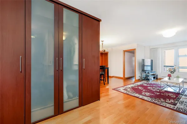 a spacious bedroom with a rug and a bathroom