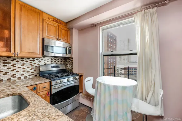 a kitchen with stainless steel appliances a stove a sink and a refrigerator