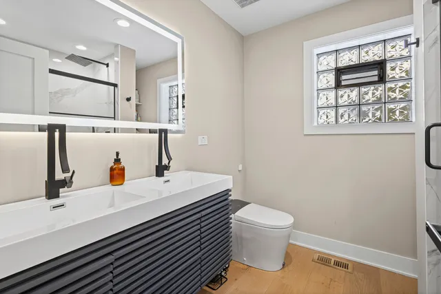 a bed room with a bed and two windows