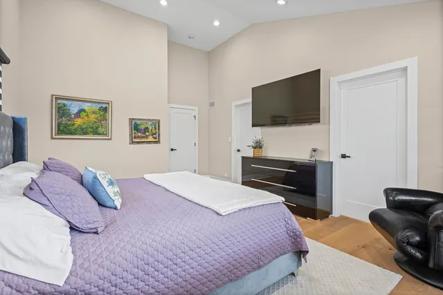 a bedroom with a large bed and a dresser