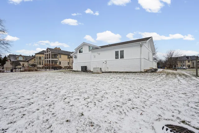 a kitchen with a sink and chairs