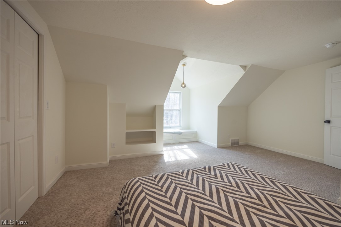32887 Cedar Road Mayfield Heights, OH 44124 - Photo 16 of 44 Bonus room featuring light colored carpet and vaulted ceiling