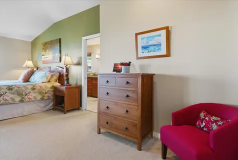 a bedroom with a bed and a couch