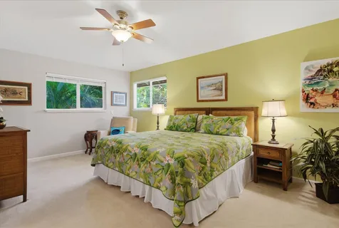 a spacious bedroom with a bed and a chandelier