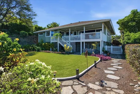 a view of a house with a swimming pool and sitting area