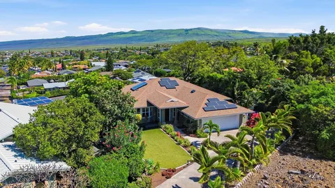 an aerial view of a house with a garden and trees