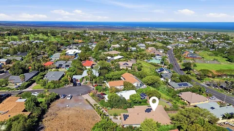 an aerial view of residential houses with outdoor space and trees