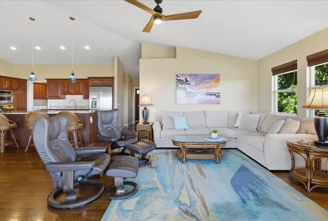 a living room with furniture gym equipment and a window