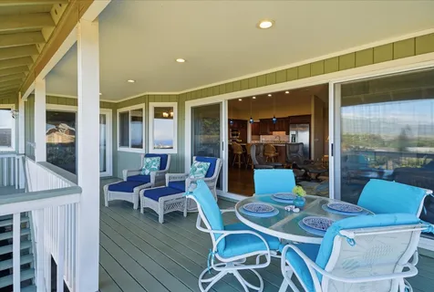 a dining room with furniture a chandelier and wooden floor