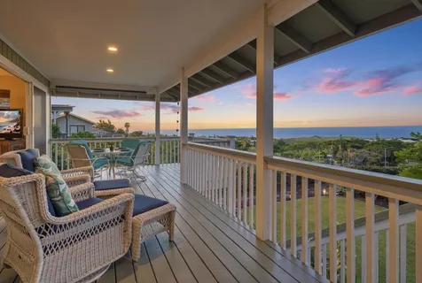 a view of a chair and tables in the balcony