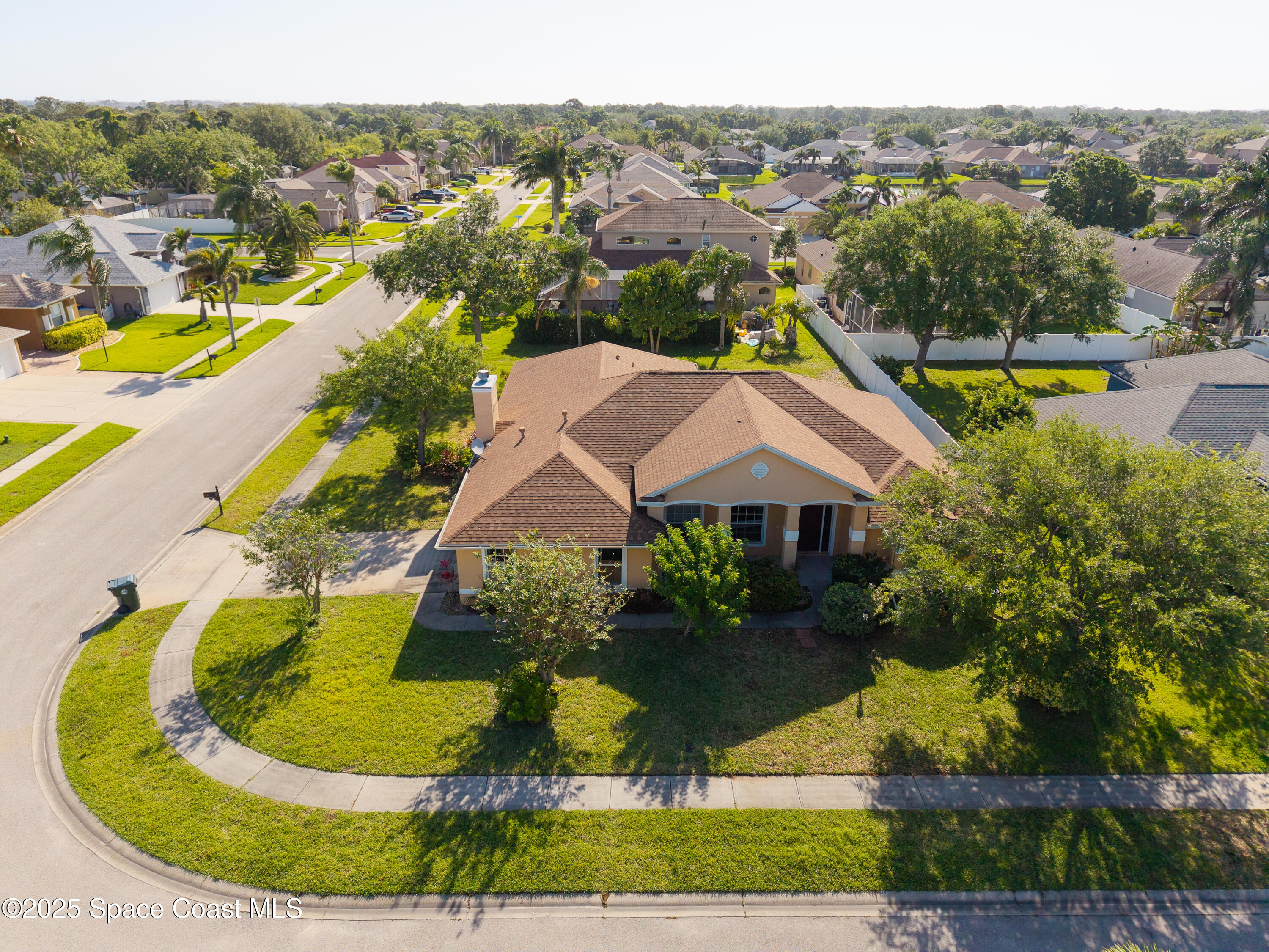 an aerial view of residential houses with outdoor space and swimming pool