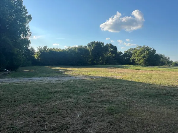a view of a swimming pool is middle in the middle of a yard