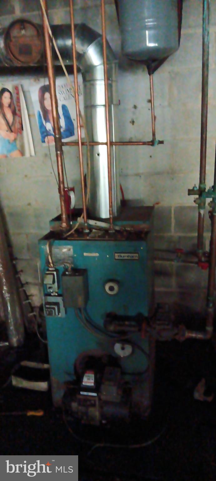 1422 Big Run Road Everett, PA 15537 - Photo 22 of 35 a room with water heater and wooden cabinets
