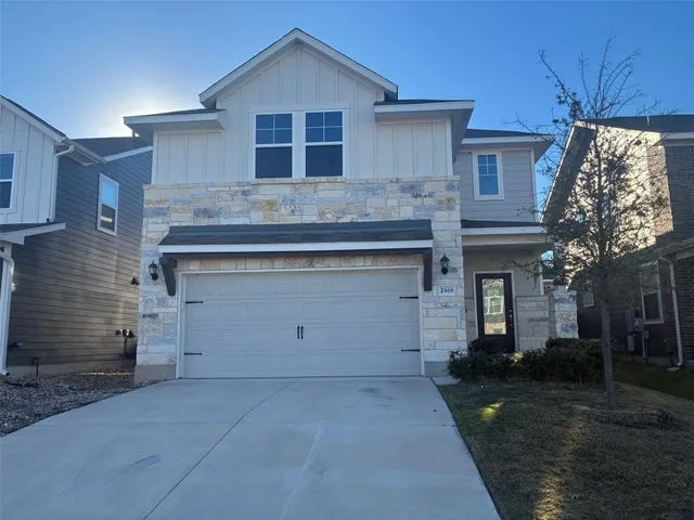 a view of a house with a yard and garage
