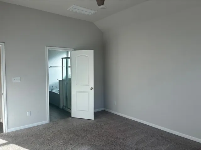 a view of an empty room and closet area