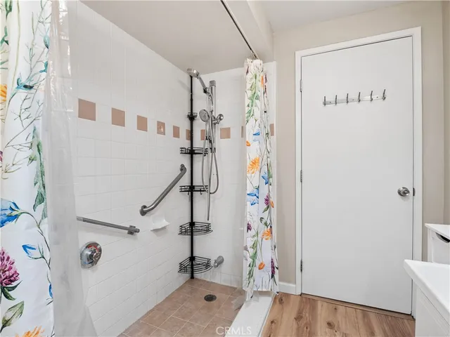 a view of bathroom with a shower and a tub
