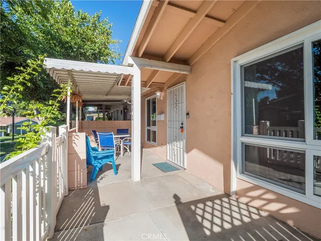 a view of a porch with a table and chairs
