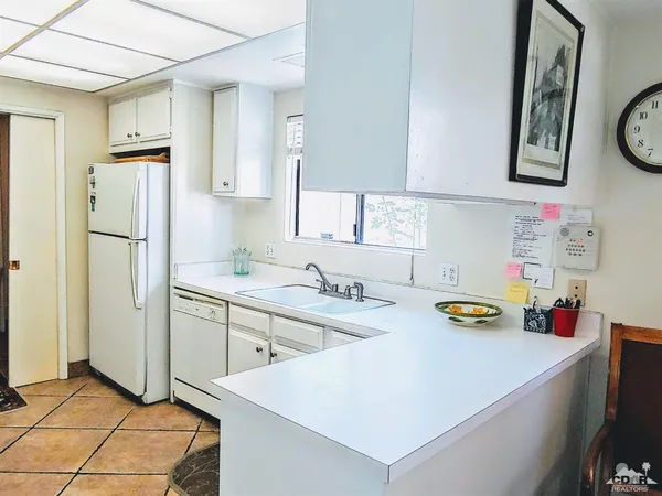 a kitchen with a sink a stove and cabinets